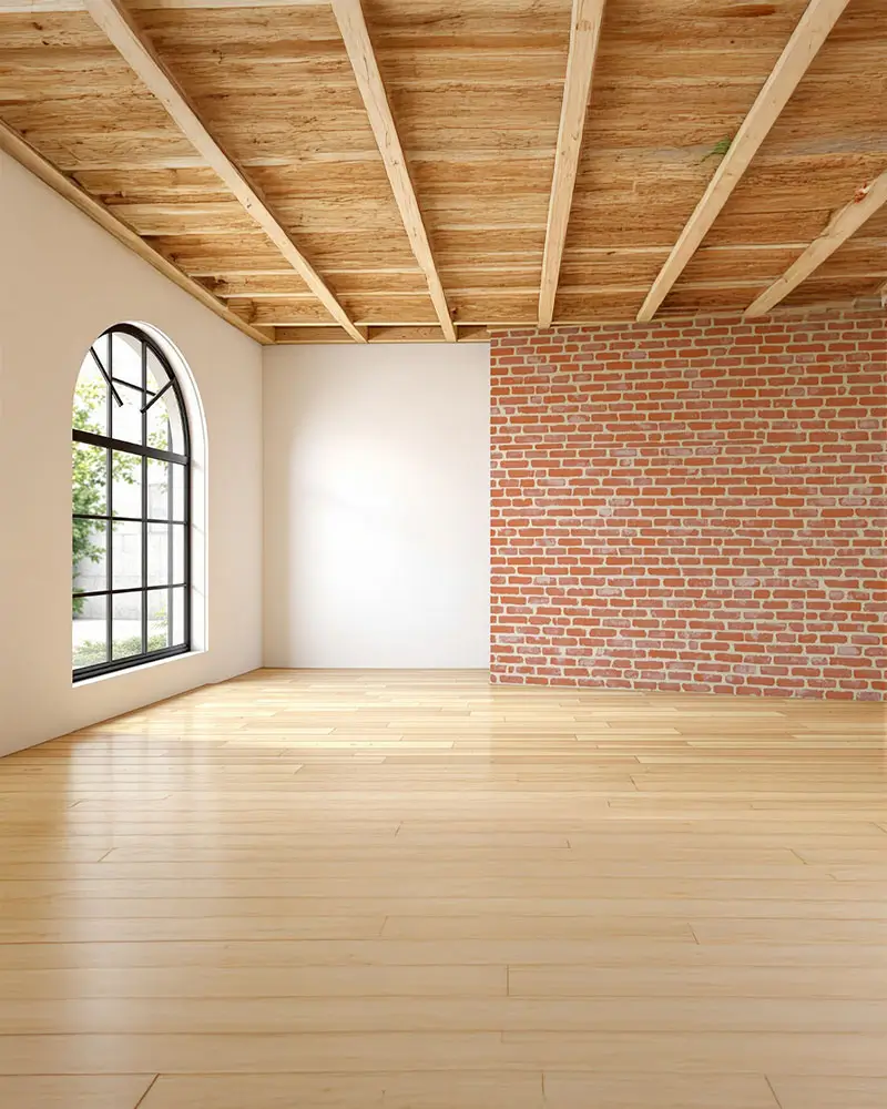Bright interior features arched window and exposed brick wall.